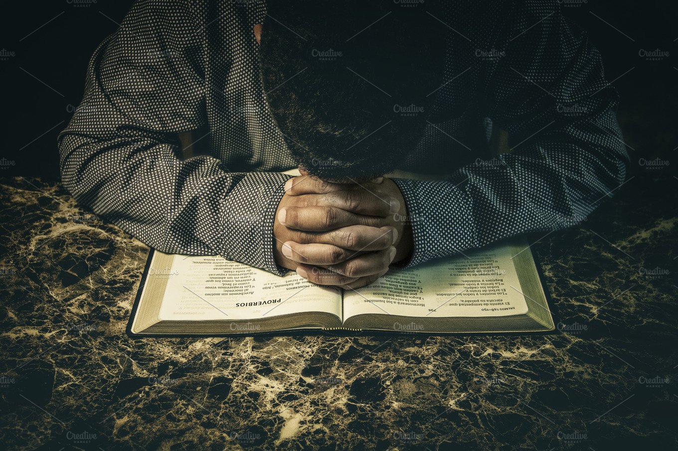 Christian praying with open Bible