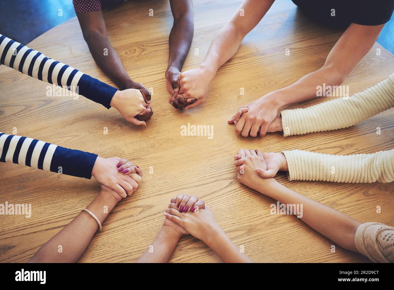 Friends praying together in a circle