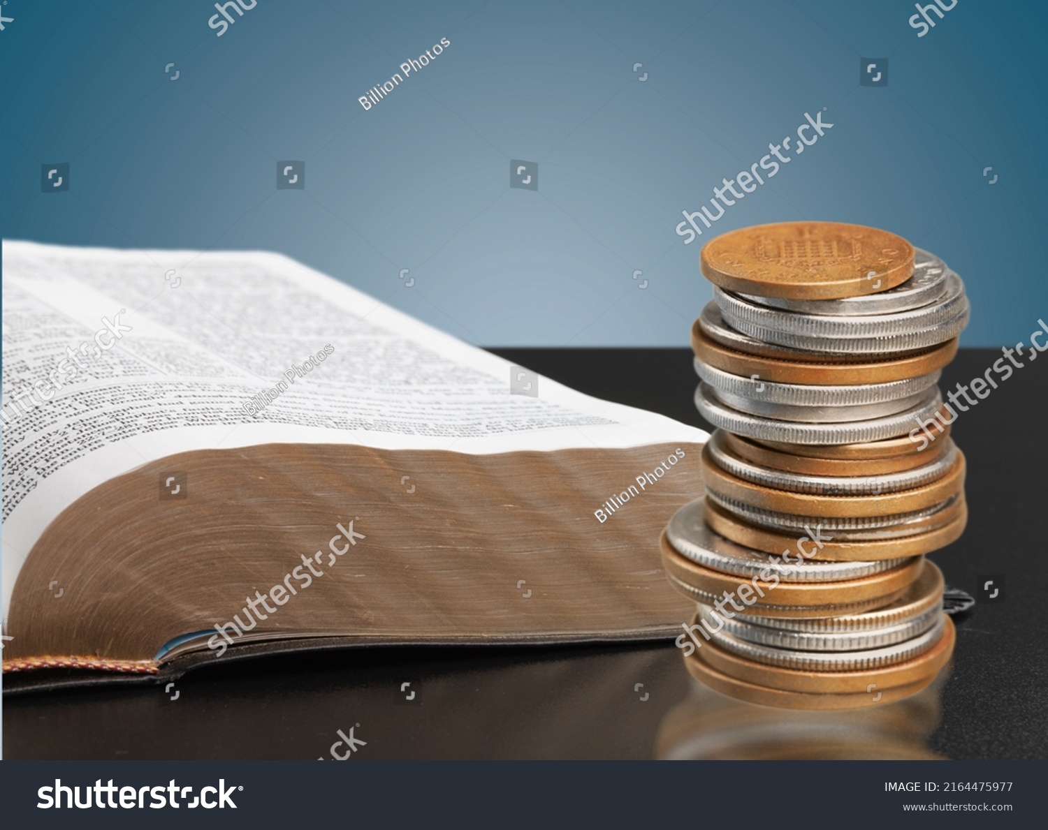 Bible and a stack of coins