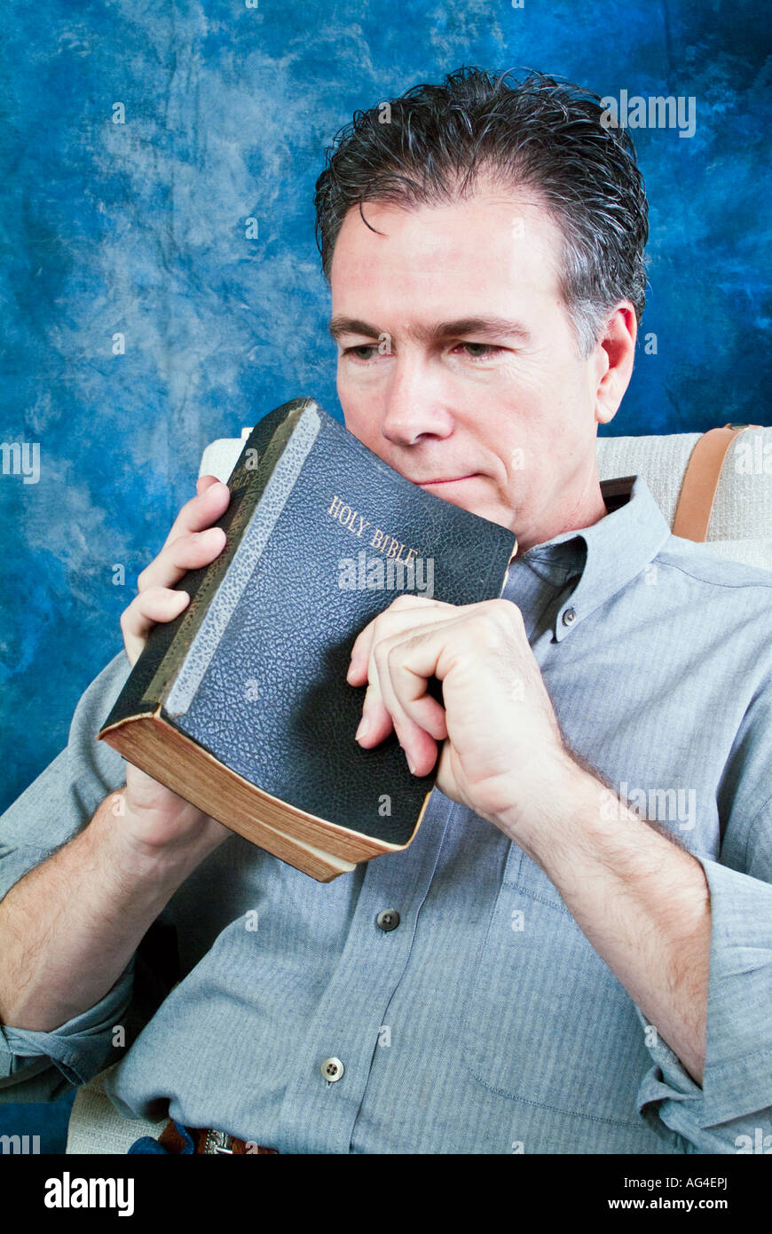 Man in contemplation with Bible in hand