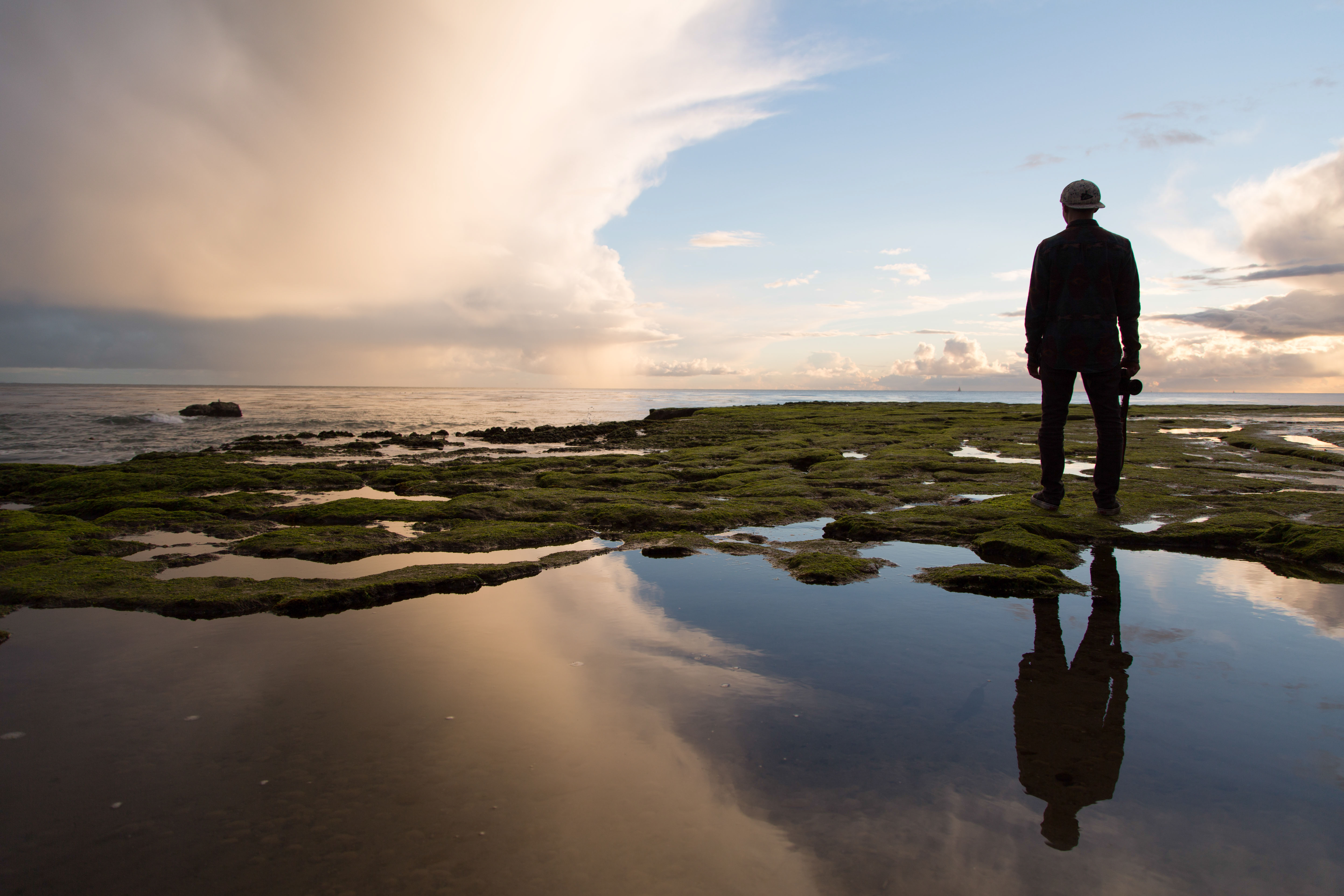 Man sitting in reflection by nature