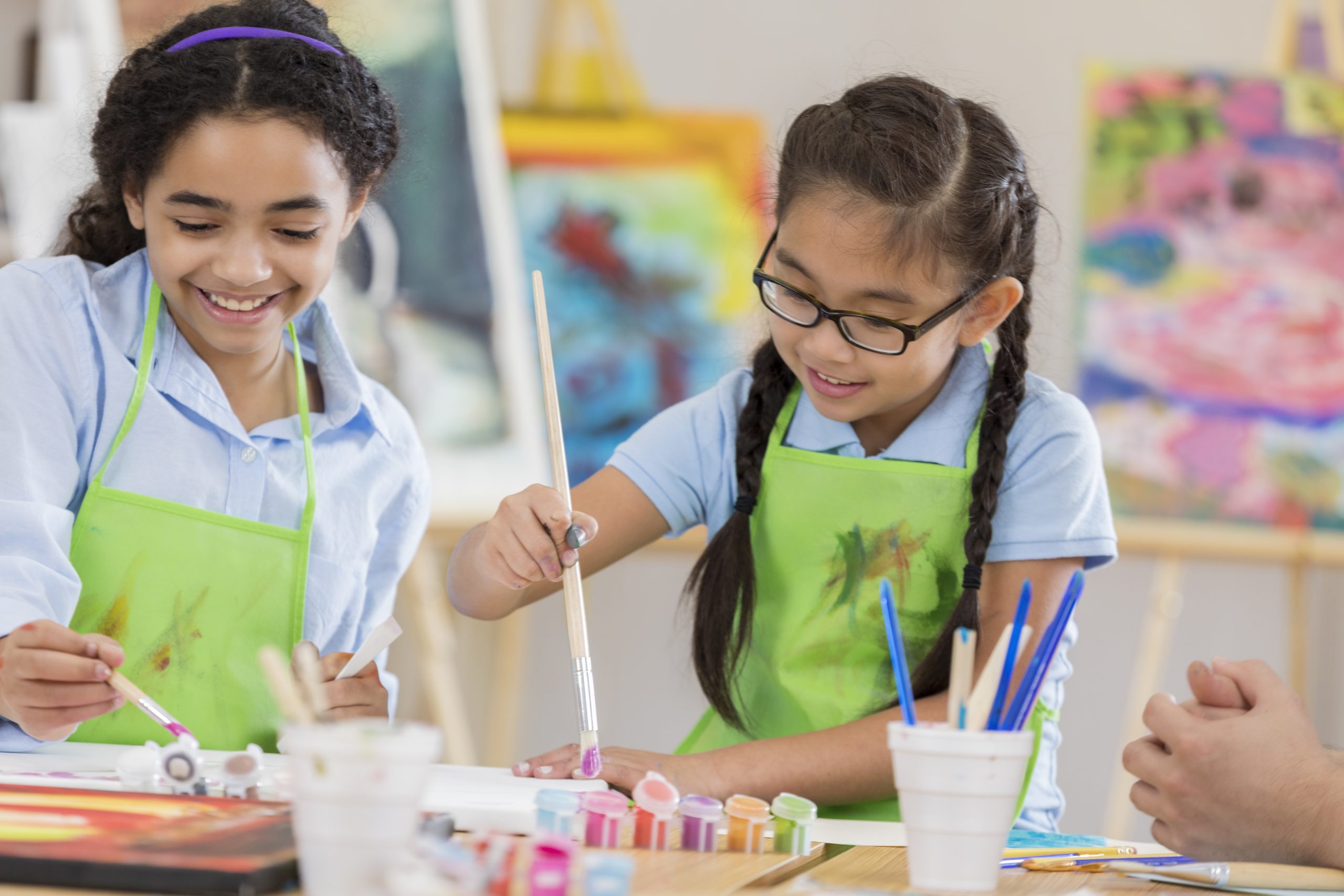 Students painting art in a classroom