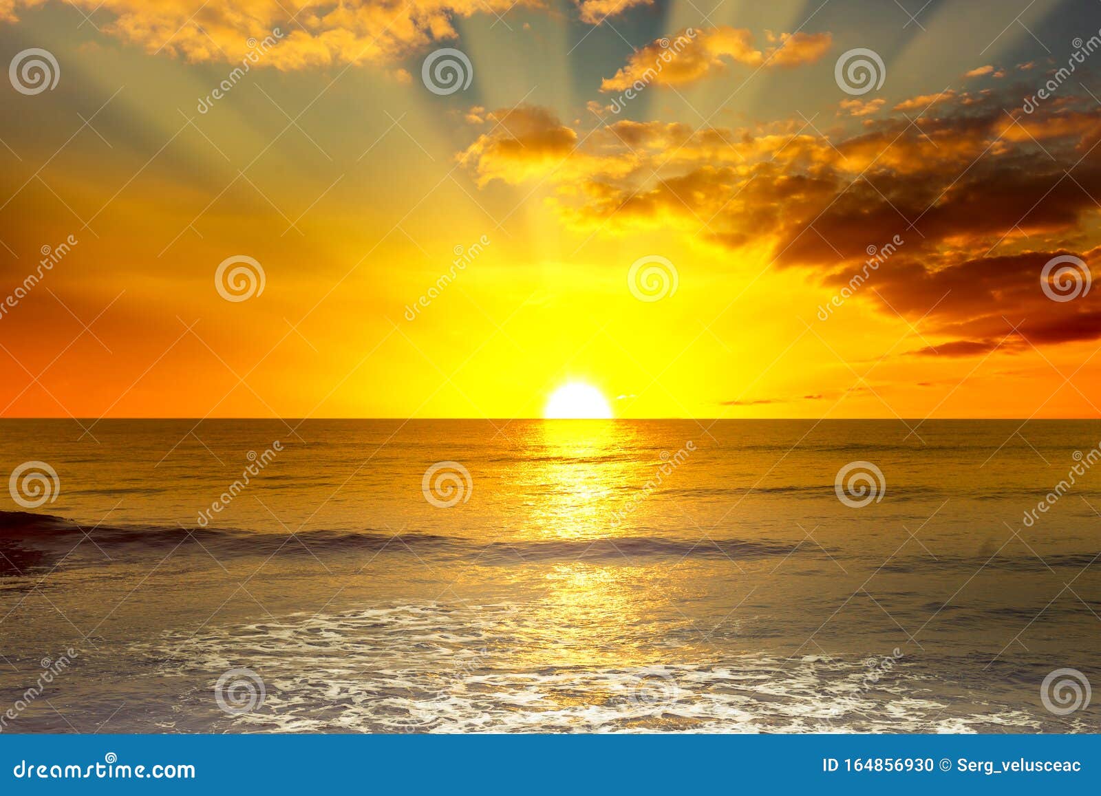 Sunrise over ocean waves