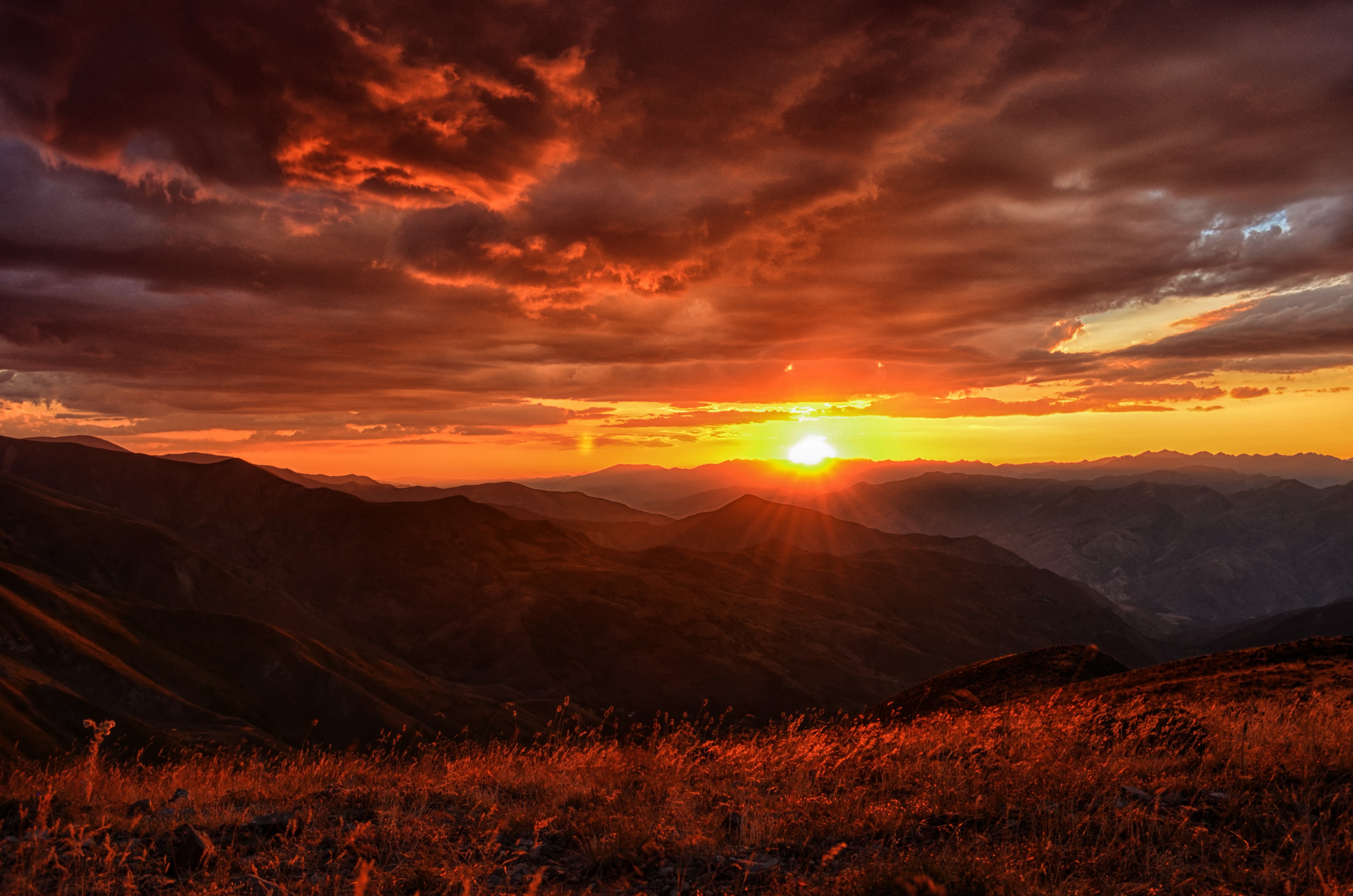 Sunset over mountains with clouds