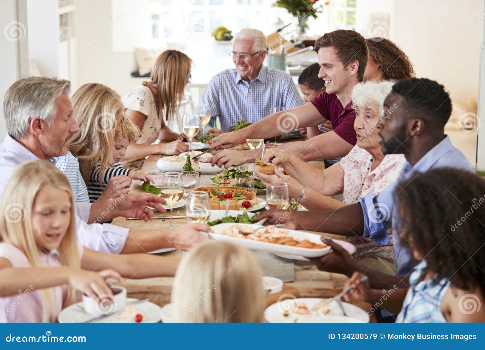 A table fellowship scene with diverse people sharing a meal together in harmony